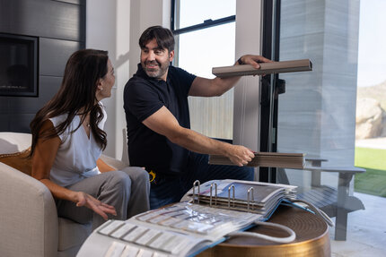 Gotcha Covered consultant showing cellular shade fabric samples during a complimentary in-home design consultation